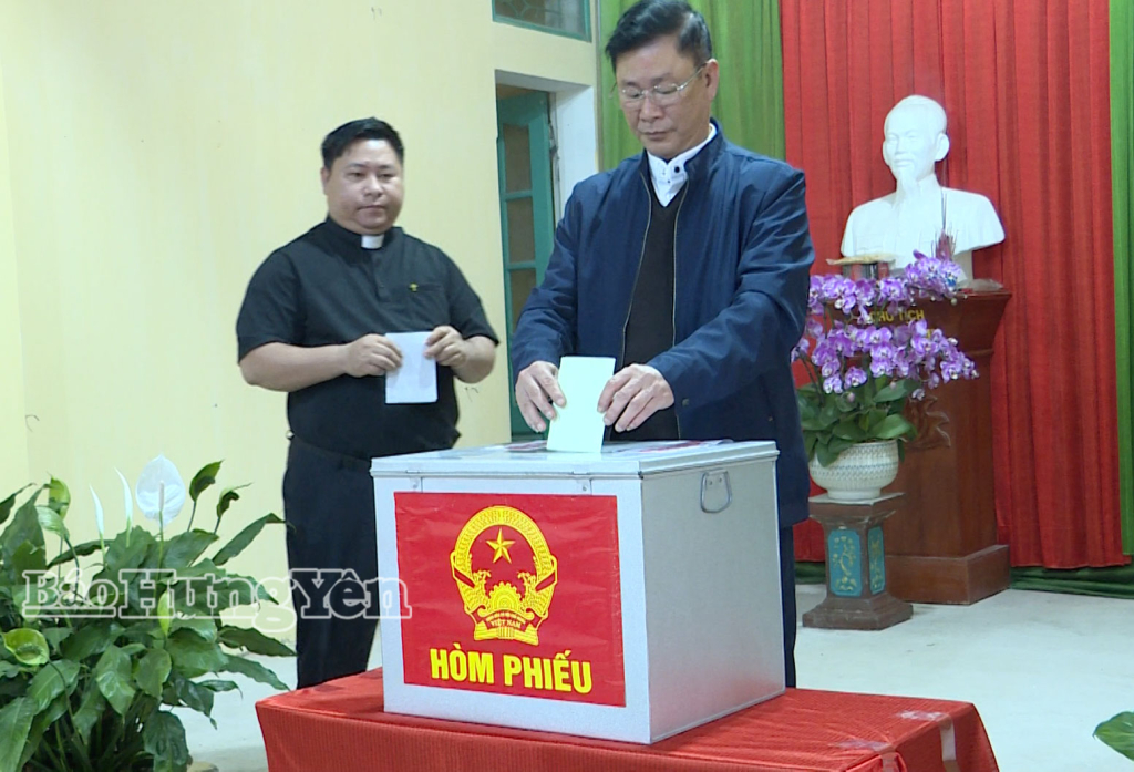 Linh mục Vũ Văn Hướng cùng đồng bào Công giáo Giáo xứ Bác Trạch tham gia bỏ phiếu tại khu vực bỏ phiếu số 10.